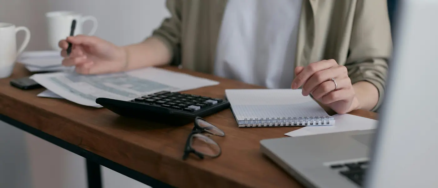 A woman doing bookkeeping for a restaurant or cafe